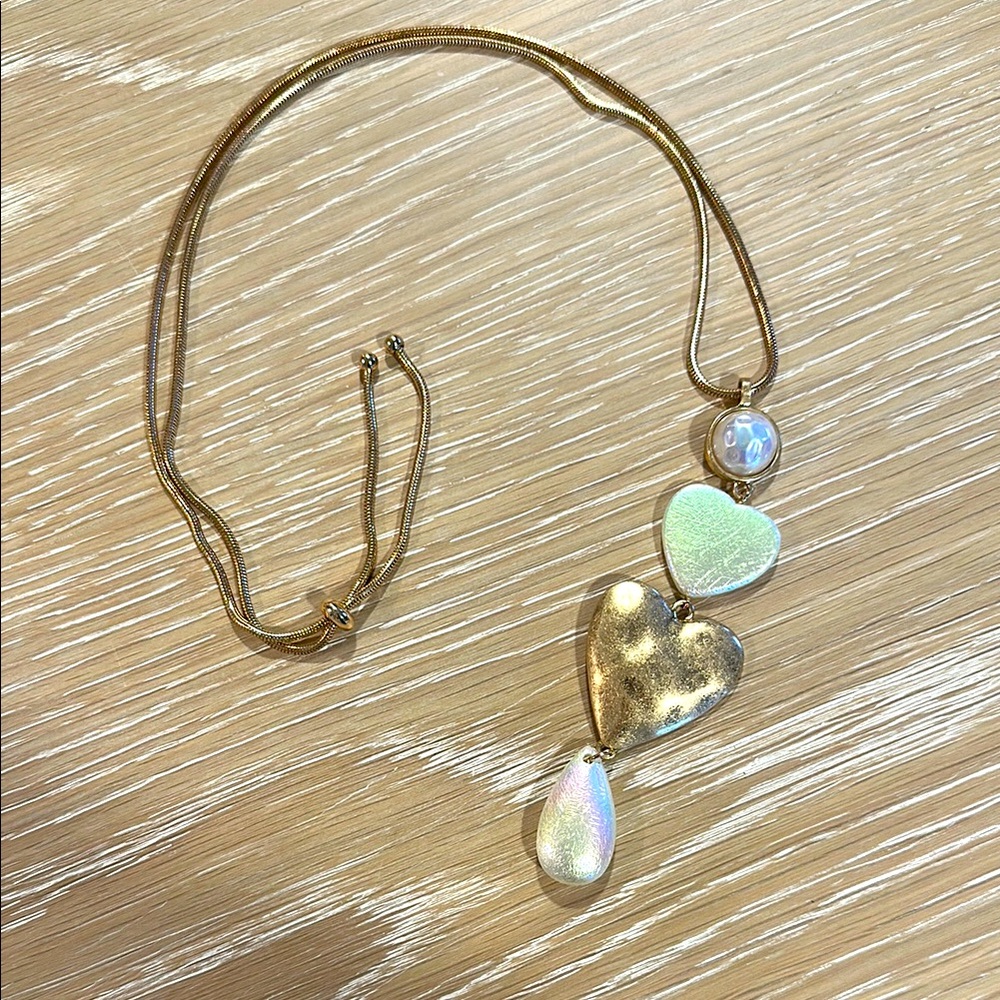 Brand new. Long heart necklace.